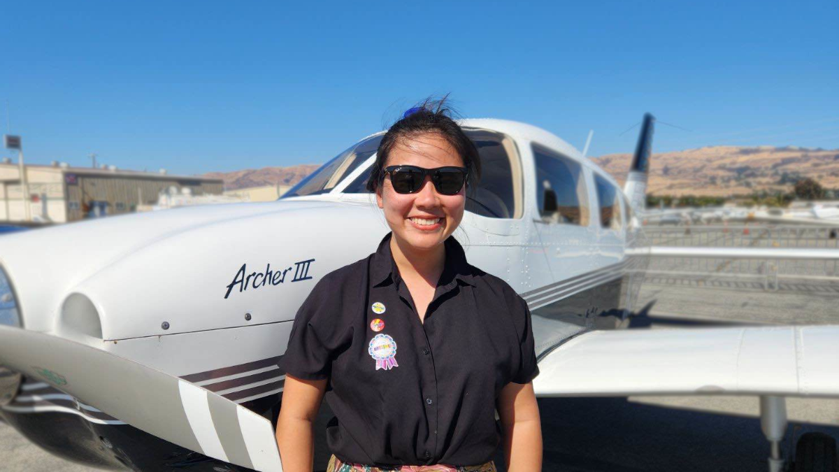 Aviation students selfie with a yellow plane background