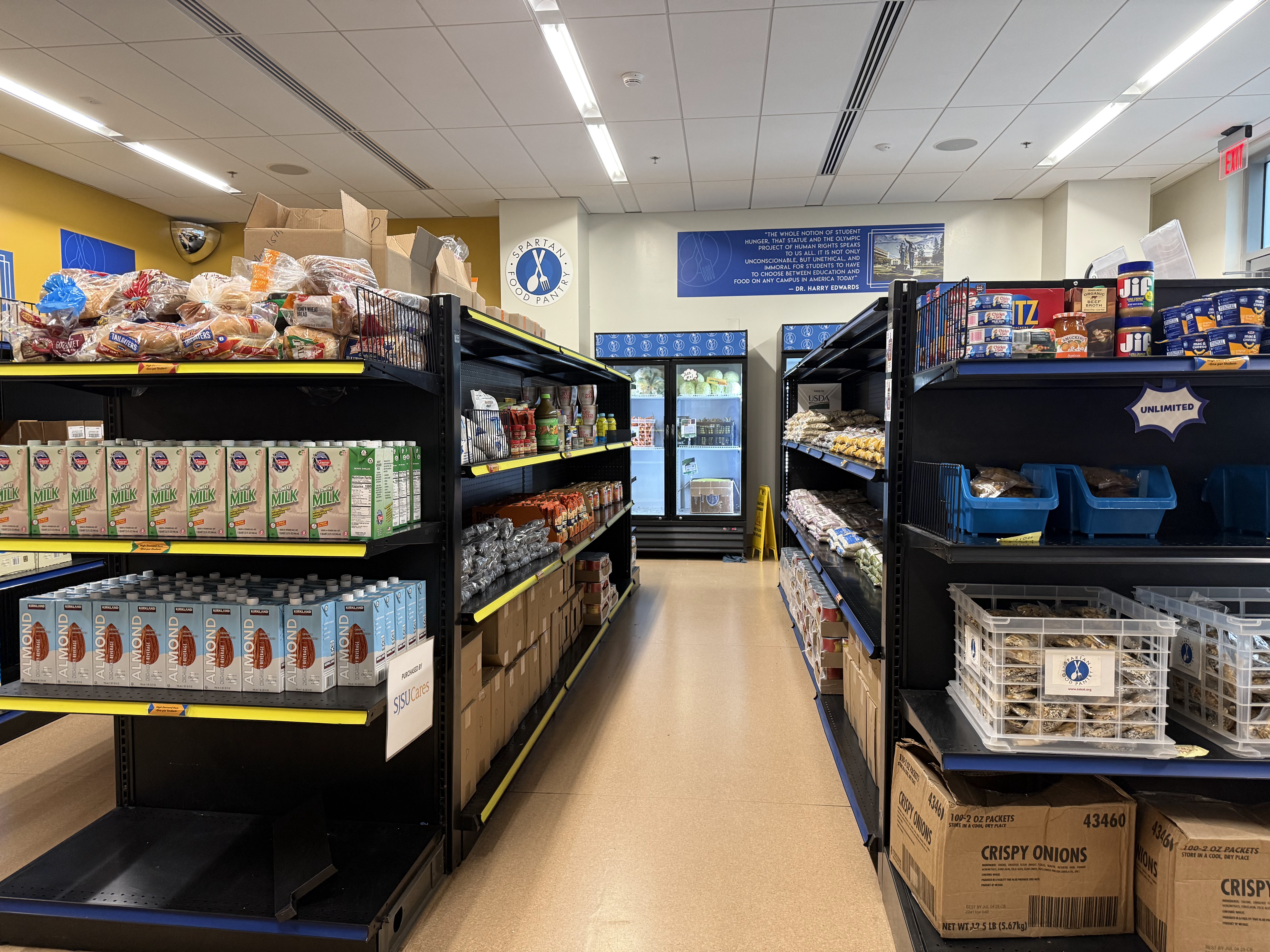Image of Spartan Food Pantry from the inside, shelves and freezers stocked with produce, canned and boxed goods sfp